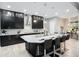 Modern kitchen with granite countertop island, stainless steel appliances, and dark cabinets at 7833 Freestyle Ln, Winter Garden, FL 34787