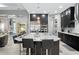 Modern kitchen with granite countertop island, stainless steel appliances, and dark cabinets at 7833 Freestyle Ln, Winter Garden, FL 34787