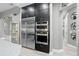Modern kitchen featuring stainless steel appliances and dark cabinets at 7833 Freestyle Ln, Winter Garden, FL 34787