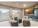 An outdoor living space features comfortable seating, a fire pit, and a roll-down movie screen at 7833 Freestyle Ln, Winter Garden, FL 34787