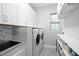 Bright laundry room features a sink, modern appliances, and ample storage space at 7833 Freestyle Ln, Winter Garden, FL 34787