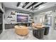 Stylish living room featuring curved couches, a glass coffee table, modern fireplace with shelving, and high ceilings at 7833 Freestyle Ln, Winter Garden, FL 34787
