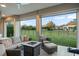Covered patio with comfortable seating, a fire pit, and a view of the well-maintained backyard and neighboring homes at 7833 Freestyle Ln, Winter Garden, FL 34787
