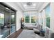 Sitting room with a neutral-colored sectional couch, two chairs, and sliding doors leading to the backyard at 7833 Freestyle Ln, Winter Garden, FL 34787