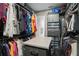 Well-lit walk-in closet with custom shelving and a center island at 7833 Freestyle Ln, Winter Garden, FL 34787