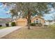 House exterior showcasing front yard landscaping and driveway at 1011 Susan Dr, Lake Wales, FL 33853