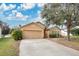 House exterior showcasing front yard landscaping and driveway at 1011 Susan Dr, Lake Wales, FL 33853