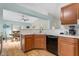 Kitchen with corner sink, dishwasher, and view to dining area at 1011 Susan Dr, Lake Wales, FL 33853