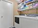Laundry room with washer, dryer, and shelving at 1011 Susan Dr, Lake Wales, FL 33853