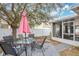 Backyard patio with seating and a pink umbrella at 1011 Susan Dr, Lake Wales, FL 33853