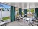 Relaxing screened porch with seating and a table at 1011 Susan Dr, Lake Wales, FL 33853