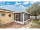 Exterior view of a screened porch with brick path at 1011 Susan Dr, Lake Wales, FL 33853