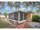 Exterior view of a screened porch with brick path at 1011 Susan Dr, Lake Wales, FL 33853