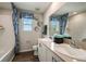 Clean bathroom with double vanity, a bathtub, and stylish wall decor at 1596 Ellesmere Ave, Haines City, FL 33844