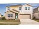 Two-story house featuring a two-car garage and landscaped front yard at 1596 Ellesmere Ave, Haines City, FL 33844