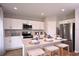 Modern kitchen with white cabinets, stainless steel appliances, and an island at 1596 Ellesmere Ave, Haines City, FL 33844