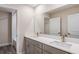 Elegant bathroom with double vanity, quartz countertop, and large mirror at 1617 Hummingbird Rd, Winter Haven, FL 33884