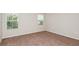 Bright bedroom with two windows and neutral-colored carpet at 4018 Gardenia Ave, Lake Hamilton, FL 33851