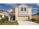 Two-story house with a neutral color scheme and a two-car garage at 4018 Gardenia Ave, Lake Hamilton, FL 33851