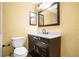 Bathroom with dark vanity, marble countertop, and large mirror at 5754 Oak Hill Manor Dr, Orlando, FL 32839