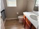 Bathroom with wood vanity, toilet and shower/tub combo at 6528 Sedgeford Dr, Lakeland, FL 33811