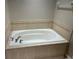 Relaxing bathtub with tile surround in a well-lit bathroom at 6528 Sedgeford Dr, Lakeland, FL 33811