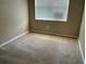 Spacious carpeted bedroom featuring a large window with blinds at 6528 Sedgeford Dr, Lakeland, FL 33811