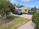 Brick driveway with landscaping and a parked car at 6528 Sedgeford Dr, Lakeland, FL 33811