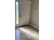 Entryway with white door and light brown laminate flooring at 6528 Sedgeford Dr, Lakeland, FL 33811