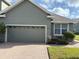 Grey house with attached two-car garage and brick driveway at 6528 Sedgeford Dr, Lakeland, FL 33811