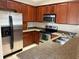 Kitchen with stainless steel appliances and wood cabinets at 6528 Sedgeford Dr, Lakeland, FL 33811