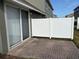 Private patio with brick pavers and a white fence at 6528 Sedgeford Dr, Lakeland, FL 33811