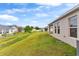 Landscaped backyard with a view of neighboring homes at 1536 Axel Cir, Winter Haven, FL 33880