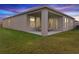Covered patio with seating area, overlooking a grassy backyard at 1536 Axel Cir, Winter Haven, FL 33880