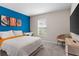 Bedroom with large bed, TV, and accent chair at 1536 Axel Cir, Winter Haven, FL 33880