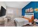 Bedroom with large bed, TV, and accent chair at 1536 Axel Cir, Winter Haven, FL 33880