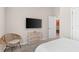 Bedroom with TV, dresser, and wicker chair at 1536 Axel Cir, Winter Haven, FL 33880