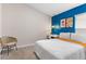 Bright bedroom with a bed and blue accent wall at 1536 Axel Cir, Winter Haven, FL 33880
