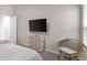 Bedroom with TV, dresser, and wicker chair at 1536 Axel Cir, Winter Haven, FL 33880