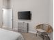 Bedroom with TV, dresser, and wicker chair at 1536 Axel Cir, Winter Haven, FL 33880