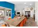 Bright dining area with wood table and orange chairs, open to the kitchen and living room at 1536 Axel Cir, Winter Haven, FL 33880