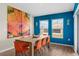 Dining room with wooden table, orange chairs and blue wall at 1536 Axel Cir, Winter Haven, FL 33880