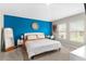 Spacious main bedroom with a large bed and blue accent wall at 1536 Axel Cir, Winter Haven, FL 33880