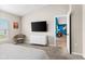 Main bedroom with dresser, TV, and view into living room at 1536 Axel Cir, Winter Haven, FL 33880