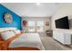 Spacious main bedroom with large bed and blue accent wall at 1536 Axel Cir, Winter Haven, FL 33880
