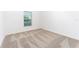 This bedroom showcases neutral carpet flooring and a window with blinds that allows natural light to flow in at 308 Bass Ct, Poinciana, FL 34759