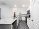 Kitchen features white cabinets, granite countertops, and stainless steel appliances at 308 Bass Ct, Poinciana, FL 34759