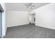 Spacious living room with plenty of natural light and gray wood-look floors at 308 Bass Ct, Poinciana, FL 34759