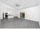 Open-concept living area with kitchen and sliding glass doors to the lanai at 308 Bass Ct, Poinciana, FL 34759