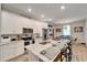 Modern kitchen with white cabinets, granite island and stainless steel appliances at 4714 Dail Rd, Lakeland, FL 33813